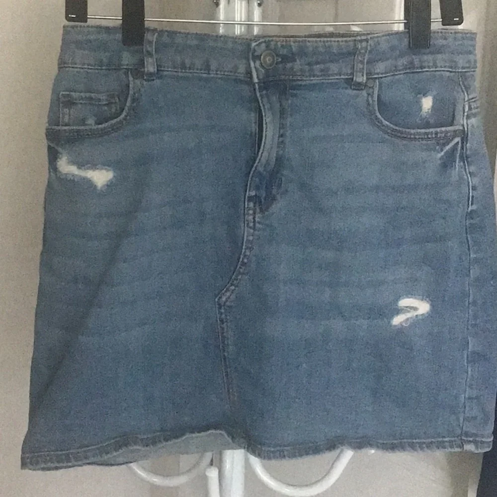 Fray features blue denim skirt with free knit top